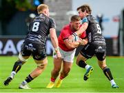 25 September 2022; Dan Goggins of Munster is tackled by Ross Moriarty, left, and Rhodri Williams of Dragons during the United Rugby Championship match between Dragons and Munster at Rodney Parade in Newport, Wales. Photo by Mark Lewis/Sportsfile