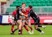 25 September 2022; Ben Healy of Munster is tackled by Jack Dixon, left, and JJ Hanrahan of Dragons during the United Rugby Championship match between Dragons and Munster at Rodney Parade in Newport, Wales. Photo by Mark Lewis/Sportsfile