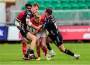 25 September 2022; Ben Healy of Munster is tackled by Jack Dixon, left, and JJ Hanrahan of Dragons during the United Rugby Championship match between Dragons and Munster at Rodney Parade in Newport, Wales. Photo by Mark Lewis/Sportsfile
