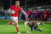 25 September 2022; Ben Healy of Munster evades the tackle of Rhodri Williams of Dragons to score his side's second try during the United Rugby Championship match between Dragons and Munster at Rodney Parade in Newport, Wales. Photo by Mark Lewis/Sportsfile