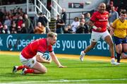 25 September 2022; Ben Healy of Munster dives to score his side's second try during the United Rugby Championship match between Dragons and Munster at Rodney Parade in Newport, Wales. Photo by Mark Lewis/Sportsfile