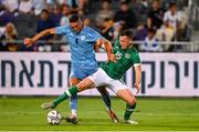 27 September 2022; Andy Lyons of Republic of Ireland in action against Roi Herman of Israel during the UEFA European U21 Championship play-off second leg match between Israel and Republic of Ireland at Bloomfield Stadium in Tel Aviv, Israel. Photo by Seb Daly/Sportsfile