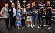 24 September 2022; Eric Donovan, with family and backroom team, including promoter Mark Dunlop, wife Laura, sons Jake and Troy, and trainer Packie Collins, after defeating Khalil El Hadri in their EBU European Union super-featherweight bout at the Europa Hotel in Belfast. Photo by Ramsey Cardy/Sportsfile