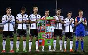 30 September 2022; Dundalk players including Greg Sloggett, third from left, and John Mountney with a banner designed by children from the Dundalk Redeemer Boys Primary School, classmates of 11 year old Calvin Gray who tragically passed away on the 20th of September, before the SSE Airtricity League Premier Division match between Dundalk and Drogheda United at Casey's Field in Dundalk, Louth. Photo by Ben McShane/Sportsfile