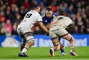 30 September 2022; Ed Byrne of Leinster is tackled by Sam Carter, left, and Nick Timoney of Ulster during the United Rugby Championship match between Ulster and Leinster at Kingspan Stadium in Belfast. Photo by Ramsey Cardy/Sportsfile