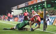 7 October 2022; Patrick Campbell of Munster scores his side's first try despite the efforts of Conor Oliver of Connacht during the United Rugby Championship match between Connacht and Munster at The Sportsground in Galway. Photo by Brendan Moran/Sportsfile