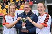 8 October 2022; PwC joint captains Aimee Kelly, left, and Maria Kinsella are presented with the trophy by Leinster LGFA President Trina Murray after winning the 2022 LGFA Interfirms Blitz at the GAA National Games Development Centre in Abbotstown, Dublin. This year, six teams competed for the top prize, while 18 teams signed up to take part in a recreational blitz. Photo by Seb Daly/Sportsfile