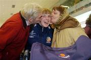 28 May 2004; The Special Olympics Ireland Women's National Football Team, sponsored by eircom, depart for the Eurofoot 2004 European 7-a-side Football Tournament, which will be held in Ettlebruck, Luxembourg from May 28 to June 1. Ireland player Bridget O'Reilly, from Swords, gets a kiss goodbye from her parents James and Teresa, at Dublin Airport. Picture credit; Brian Lawless / SPORTSFILE