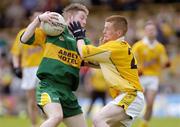 30 May 2004; Garreth Cotter, Donegal, is tackled by Ciaran McKeown, Antrim. Ulster Minor Football Championship, Donegal v Antrim, McCool Park, Ballybofey, Co. Donegal. Picture credit; Damien Eagers / SPORTSFILE