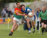 30 May 2004; Colm Parkinson, Laois, in action against Joe Byrne, Carlow. Bank of Ireland Leinster Senior Football Championship, Carlow v Laois, Dr. Cullen Park, Carlow. Picture credit; David Maher / SPORTSFILE