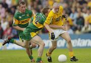 30 May 2004; Kevin McGourty, Antrim, is tackled by Stephen McDermott, 12, Donegal. Bank of Ireland Ulster Senior Football Championship, Donegal v Antrim, McCool Park, Ballybofey, Co. Donegal. Picture credit; Damien Eagers / SPORTSFILE