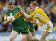 30 May 2004; Stephen McDermott, Donegal, is tackled by Tony Convery, Antrim. Bank of Ireland Ulster Senior Football Championship, Donegal v Antrim, McCool Park, Ballybofey, Co. Donegal. Picture credit; Damien Eagers / SPORTSFILE