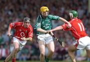 30 May 2004; Niall Moran, Limerick, is tackled by Niall McCarthy, 11, and John Gardiner, Cork. Guinness Munster Senior Hurling Championship Semi-Final, Limerick v Cork, Gaelic Grounds, Limerick. Picture credit; Ray McManus / SPORTSFILE