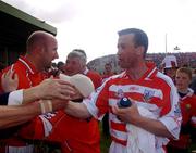 30 May 2004; Cork players Donal Og Cusack and Brian Corcoran, left, after the game. Guinness Munster Senior Hurling Championship Semi-Final, Limerick v Cork, Gaelic Grounds, Limerick. Picture credit; Ray McManus / SPORTSFILE