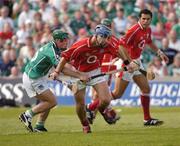 30 May 2004; Ronan Curran, Cork, is tackled by Donnacha Sheehan, Limerick. Guinness Munster Senior Hurling Championship Semi-Final, Limerick v Cork, Gaelic Grounds, Limerick. Picture credit; Ray McManus / SPORTSFILE