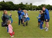 13 August 2013; Leinster's Brian O'Driscoll, right, poses for a photograph with camp participants while team-mate Fergus McFadden signs autographs, during a Leinster Rugby Summer Camp at DLSP RFC, Kirwan Park, Kilternan, Co. Dublin. Picture credit: Brian Lawless / SPORTSFILE
