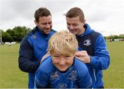 13 August 2013; Leinster players Fergus McFadden, left, and Brian O'Driscoll sign autographs for Peter Lane, age 11, from Sandyford, Dublin, during a Leinster Rugby Summer Camp at DLSP RFC, Kirwan Park, Kilternan, Co. Dublin. Picture credit: Brian Lawless / SPORTSFILE