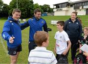 13 August 2013; Leinster players Brian O'Driscoll, left, and Fergus McFadden greet camp participants during a Leinster Rugby Summer Camp at DLSP RFC, Kirwan Park, Kilternan, Co. Dublin. Picture credit: Brian Lawless / SPORTSFILE