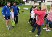 13 August 2013; Leinster players Brian O'Driscoll, left, and Fergus McFadden, pose for a photograph with a camp participant during a Leinster Rugby Summer Camp at DLSP RFC, Kirwan Park, Kilternan, Co. Dublin. Picture credit: Brian Lawless / SPORTSFILE