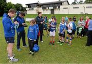 13 August 2013; Leinster players Brian O'Driscoll, left, and Fergus McFadden, sign autographs for camp participants during a Leinster Rugby Summer Camp at DLSP RFC, Kirwan Park, Kilternan, Co. Dublin. Picture credit: Brian Lawless / SPORTSFILE