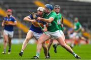 9 October 2022; Paul Flynn of Kiladangan in action against Michael Campion of Drom and Inch during the Tipperary County Senior Hurling Championship Semi-Final match between Drom and Inch and Kiladangan at FBD Semple Stadium in Thurles, Tipperary. Photo by Michael P Ryan/Sportsfile