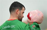 9 October 2022; Barry McKeon of Colmcille, with his daughter Maisie, age 1, in the pre-match parade before the Longford County Senior Football Championship Final match between Mullinalaghta St Columba's and Colmcille at Glennon Brothers Pearse Park in Longford. Photo by Ramsey Cardy/Sportsfile