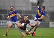 9 October 2022; Paddy O'Sullivan of Portarlington in action against Micheál Finlay, right, and Jack Lennon, both of O'Dempseys during the Laois County Senior Football Championship Final match between O'Dempseys and Portarlington at MW Hire O'Moore Park in Portlaoise, Laois. Photo by Sam Barnes/Sportsfile