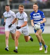9 October 2022; Paddy McDermot of Naas in action against Shane McCormack and Cormac Vizzard, left, of Clane during the Kildare County Senior Football Championship Final match between Clane and Naas at St Conleth's Park in Newbridge, Kildare. Photo by Stephen Marken/Sportsfile