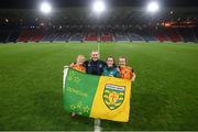 11 October 2022; Republic of Ireland players and staff, from left, Amber Barrett, StatSports technician Niamh McDaid, Roma McLaughlin and Ciara Grant celebrate with a Donegal flag the FIFA Women's World Cup 2023 Play-off match between Scotland and Republic of Ireland at Hampden Park in Glasgow, Scotland. Photo by Stephen McCarthy/Sportsfile