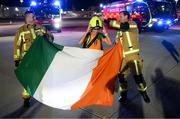 12 October 2022; Republic of Ireland captain Katie McCabe with members of Dublin Airport Fire and Rescue Service Mick Power, left, and David Brennan on the team's return to Dublin Airport after securing their qualification for the FIFA Women's World Cup 2023 in Australia and New Zealand following their play-off victory over Scotland at Hampden Park on Tuesday. Photo by Stephen McCarthy/Sportsfile