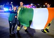 12 October 2022; Republic of Ireland's Harriet Scott with members of Dublin Airport Fire and Rescue Service Mick Power, left, and David Brennan on the team's return to Dublin Airport after securing their qualification for the FIFA Women's World Cup 2023 in Australia and New Zealand following their play-off victory over Scotland at Hampden Park on Tuesday. Photo by Stephen McCarthy/Sportsfile