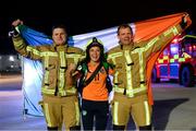 12 October 2022; Republic of Ireland captain Katie McCabe with members of Dublin Airport Fire and Rescue Service Mick Power, left, and David Brennan on the team's return to Dublin Airport after securing their qualification for the FIFA Women's World Cup 2023 in Australia and New Zealand following their play-off victory over Scotland at Hampden Park on Tuesday. Photo by Stephen McCarthy/Sportsfile