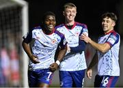 14 October 2022; Serge Atakayi of St Patrick's Athletic, left, celebrates with teammates Chris Forrester, centre, and Adam O'Reilly after scoring their side's first goal during the SSE Airtricity League Premier Division match between St Patrick's Athletic and Bohemians at Richmond Park in Dublin. Photo by Seb Daly/Sportsfile