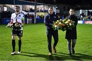 14 October 2022; Dundalk captain Andy Boyle, left, and League of Ireland director Mark Scanlon, right, and Republic of Ireland U19 head coach Tom Mohan bring out wreaths in remembrance of the people who lost their lives in the Creeslough tragedy in Donegal before the SSE Airtricity League Premier Division match between Finn Harps and Dundalk at Finn Park in Ballybofey, Donegal. Photo by Ben McShane/Sportsfile