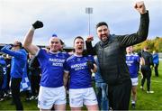 15 October 2022; Naomh Conaill players Dermot Molloy, left, and Leo McLoone, centre, celebrate after their side's victory in the Donegal County Senior Club Football Championship Final between Naomh Conaill and St Eunan's at Páirc Sheáin Mhic Cumhaill in Ballybofey, Donegal. Photo by Piaras Ó Mídheach/Sportsfile