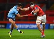 15 October 2022; Thomas Ahern of Munster holds off the tackle of David Kriel of Vodacom Bulls during the United Rugby Championship match between Munster and Vodacom Bulls at Thomond Park in Limerick. Photo by Brendan Moran/Sportsfile
