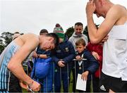 16 October 2022; Darragh McElhinney of UCD AC, Dublin, left, and Keelan Kilrehill of Moy Valley AC, Kildare, sign autographs after finishing first and second respectively in the senior men's 7500m during the Autumn Open International Cross Country Festival at the Sport Ireland Campus in Dublin. Photo by Sam Barnes/Sportsfile