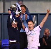 16 October 2022; Kilmacud Crokes captain Shane Cunningham lifts the cup with supporter Connell Gallagher after the Dublin County Senior Club Championship Football Final match between Kilmacud Crokes and Na Fianna at Parnell Park in Dublin. Photo by Daire Brennan/Sportsfile