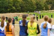 16 October 2022; Athletes watch on as their team-mates compete in the u15 girls 4x1000m event at the Inter-Club Cross Country Relays 2022 during the Autumn International Cross Country Festival 2022 at the Sport Ireland Campus in Dublin. Photo by Sam Barnes/Sportsfile