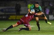 21 October 2022; Tiernan O'Halloran of Connacht is tackled by Ken Owens of Scarlets during the United Rugby Championship match between Connacht and Scarlets at The Sportsground in Galway. Photo by David Fitzgerald/Sportsfile