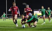 21 October 2022; Mack Hansen of Connacht scores his side's fourth try despite the efforts of Johnny McNicholl of Scarlets during the United Rugby Championship match between Connacht and Scarlets at The Sportsground in Galway. Photo by Brendan Moran/Sportsfile