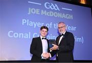 21 October 2022; Antrim hurler Conal Cunning receives the Joe McDonagh player of the year award from Uachtarán Chumann Lúthchleas Gael Larry McCarthy during the GAA Champion 15 Awards at Croke Park in Dublin. Photo by Harry Murphy/Sportsfile