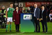 21 October 2022; Cork City captain Cian Coleman receives the cup from, from left, SSE Airtricity marketing executive Ruth Rapple, An Taoiseach Micheál Martin TD and League of Ireland director Mark Scanlon after the SSE Airtricity League First Division match between Cork City and Bray Wanderers at Turners Cross in Cork. Photo by Eóin Noonan/Sportsfile