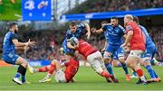 22 October 2022; Garry Ringrose of Leinster is tackled by Liam Coombes, left, and John Hodnett of Munster during the United Rugby Championship match between Leinster and Munster at Aviva Stadium in Dublin. Photo by Ramsey Cardy/Sportsfile