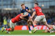 22 October 2022; Ciarán Frawley of Leinster is tackled by Liam Coombes, left, and Rory Scannell of Munsterduring the United Rugby Championship match between Leinster and Munster at Aviva Stadium in Dublin. Photo by Ramsey Cardy/Sportsfile