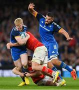 22 October 2022; Jamie Osborne of Leinster is tackled by Rory Scannell, left, and Jack O'Donoghue of Munster during the United Rugby Championship match between Leinster and Munster at Aviva Stadium in Dublin. Photo by Ramsey Cardy/Sportsfile