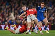 22 October 2022; Rob Russell of Leinster is tackled by Dan Goggin and Shane Daly of Munster during the United Rugby Championship match between Leinster and Munster at Aviva Stadium in Dublin. Photo by Brendan Moran/Sportsfile