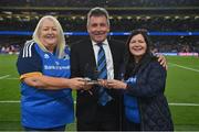 22 October 2022; Mary Carroll, left, and Bebhinn Dunne, on behalf of the Official Leinster Supporters Club, make a presentation to outgoing Leinster chief executive officer Michael Dawson at half-time in the United Rugby Championship match between Leinster and Munster at Aviva Stadium in Dublin. Photo by Brendan Moran/Sportsfile