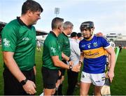 23 October 2022; Alan Flynn of Kiladangan shakes hands with referee Kevin Jordan and his officials before the Tipperary County Senior Club Hurling Championship Final match between Kilruane MacDonaghs and Kiladangan at Semple Stadium in Thurles, Tipperary. Photo by Eóin Noonan/Sportsfile
