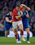 22 October 2022; Liam Coombes of Munster is tackled by Cian Healy and Jonathan Sexton of Leinster during the United Rugby Championship match between Leinster and Munster at Aviva Stadium in Dublin. Photo by Brendan Moran/Sportsfile